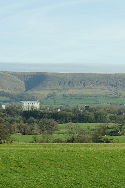 green fields and hills in the background